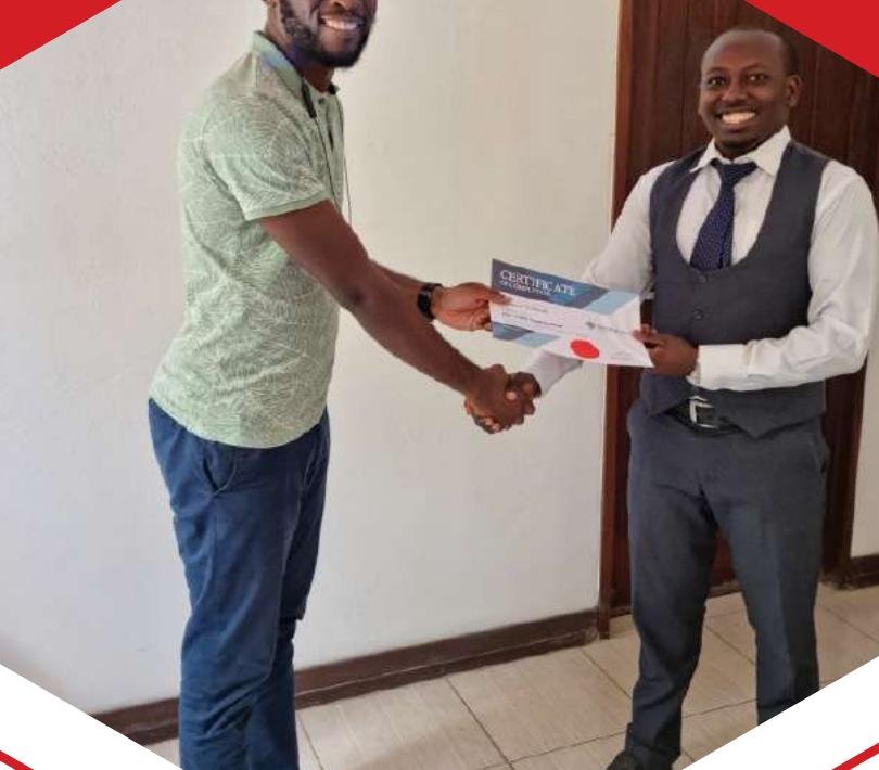 Rigel Kenya presenting a certificate of completion to a training participant